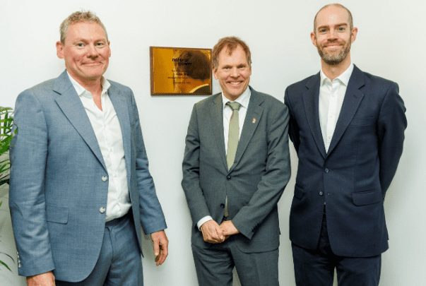 Three men in suits at the opening of Natural Power's new Dublin office.