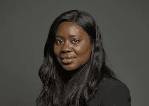 Headshot of Miatta Fahnbulleh MP against a dark background.