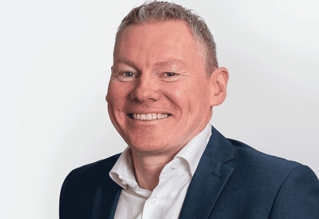 Headshot of Ciaran Farrell, the new Managing Director of Natural Power, smiling, in a suit.