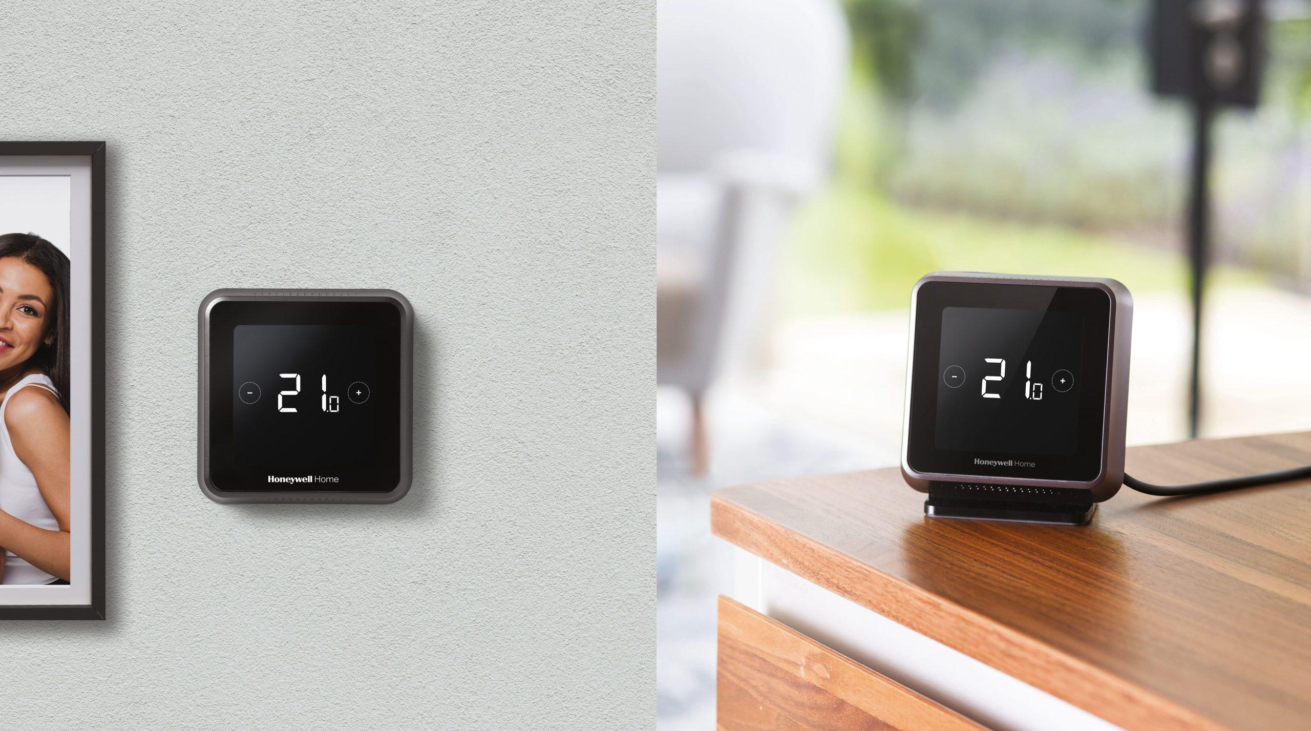 Two Honeywell Home T6 smart thermostats, one mounted on a wall and one on a table stand.
