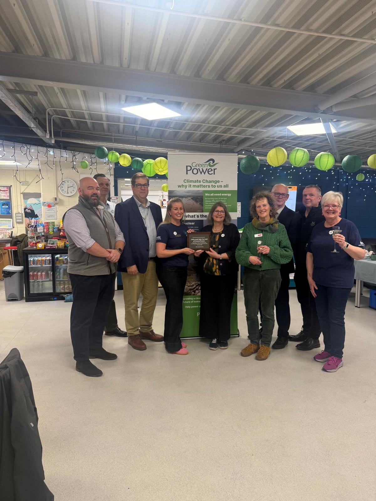 A group of people hold a certificate at the formal opening of the solar installation at the Dunblane Centre.